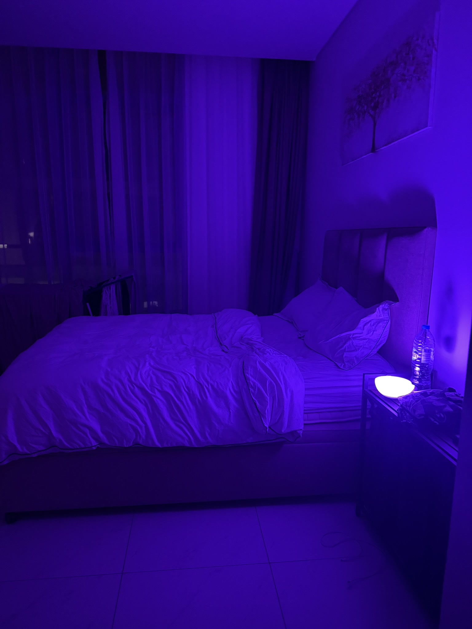 Bedroom with blue Philips Hue nightstand lamp creating ambient atmosphere