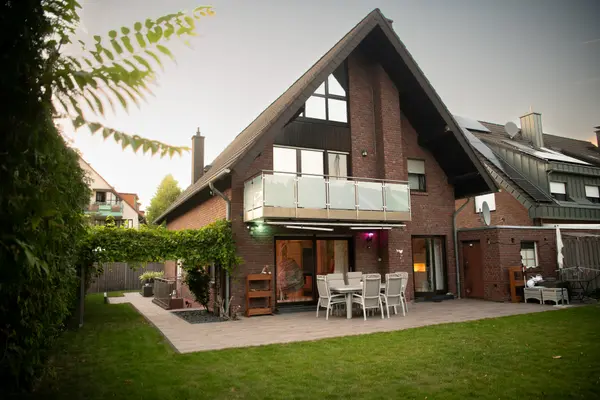 German villa exterior with smart lighting at dusk